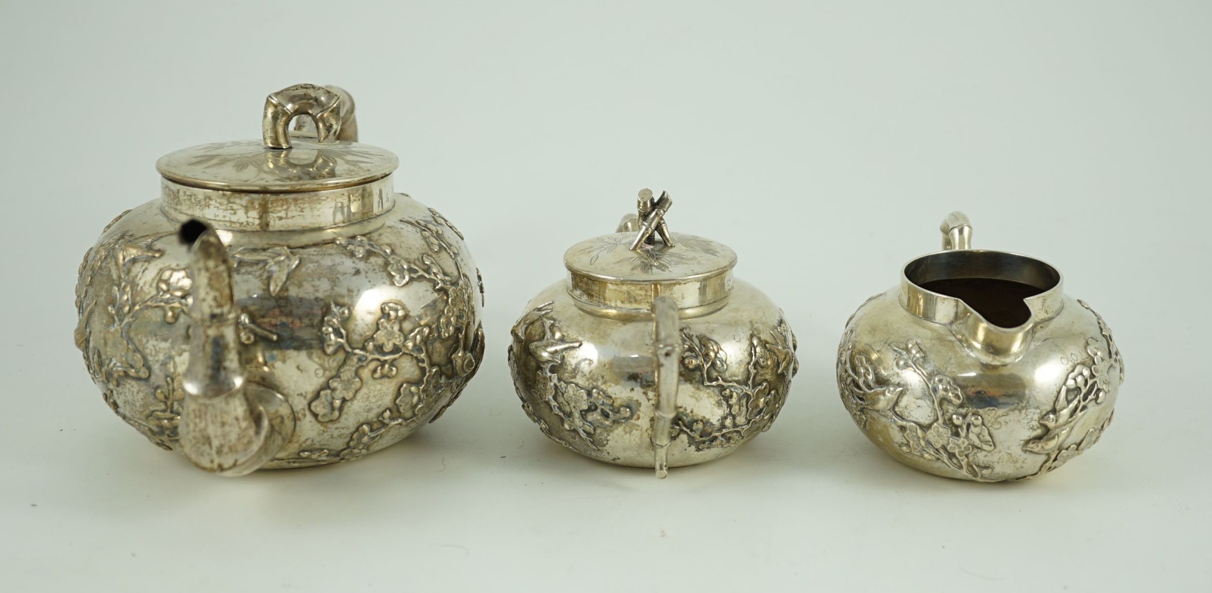 A 19th century Chinese Export silver three piece tea set by Cumshing?